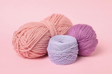 Photo of Soft colorful woolen yarns on pink background