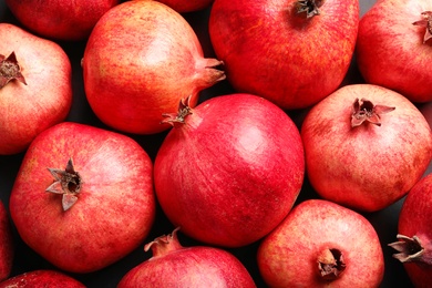 Ripe red pomegranates on grey background, top view