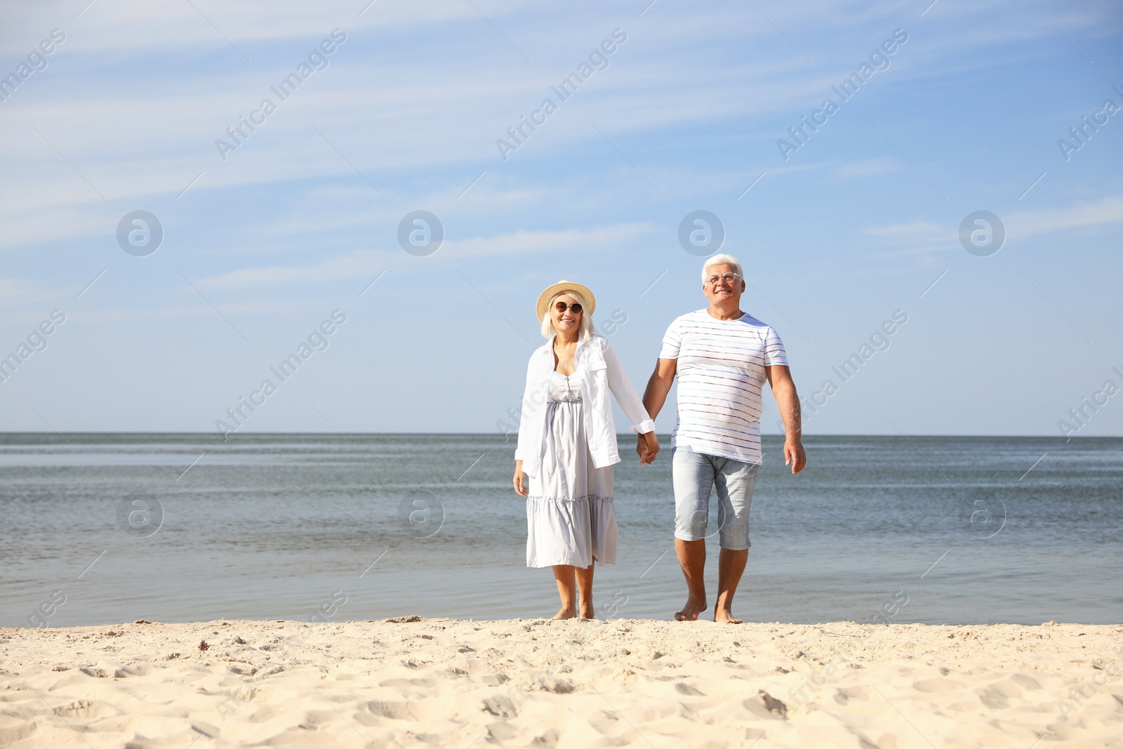 Photo of Mature couple spending time together on sea beach