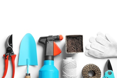 Flat lay composition with professional gardening tools on white background