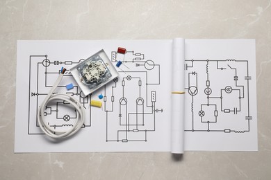 Photo of Wiring diagrams, wires and disassembled light switch on light table, flat lay