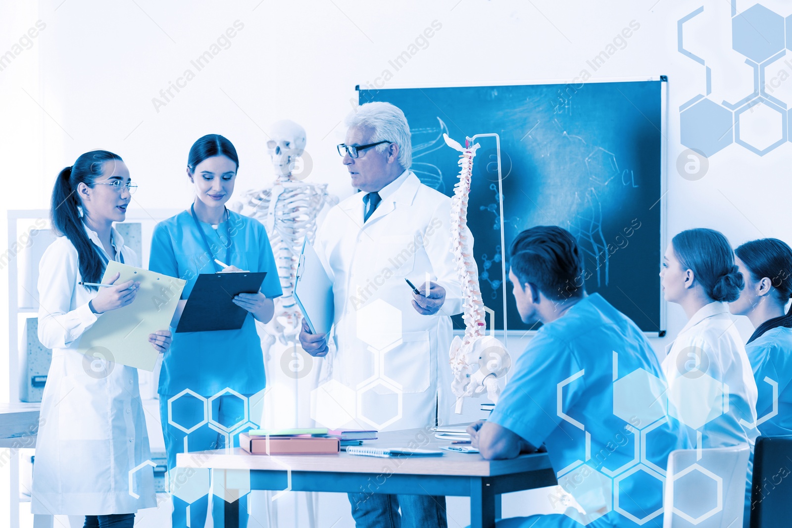 Image of Medical students and professor studying human spine structure in classroom