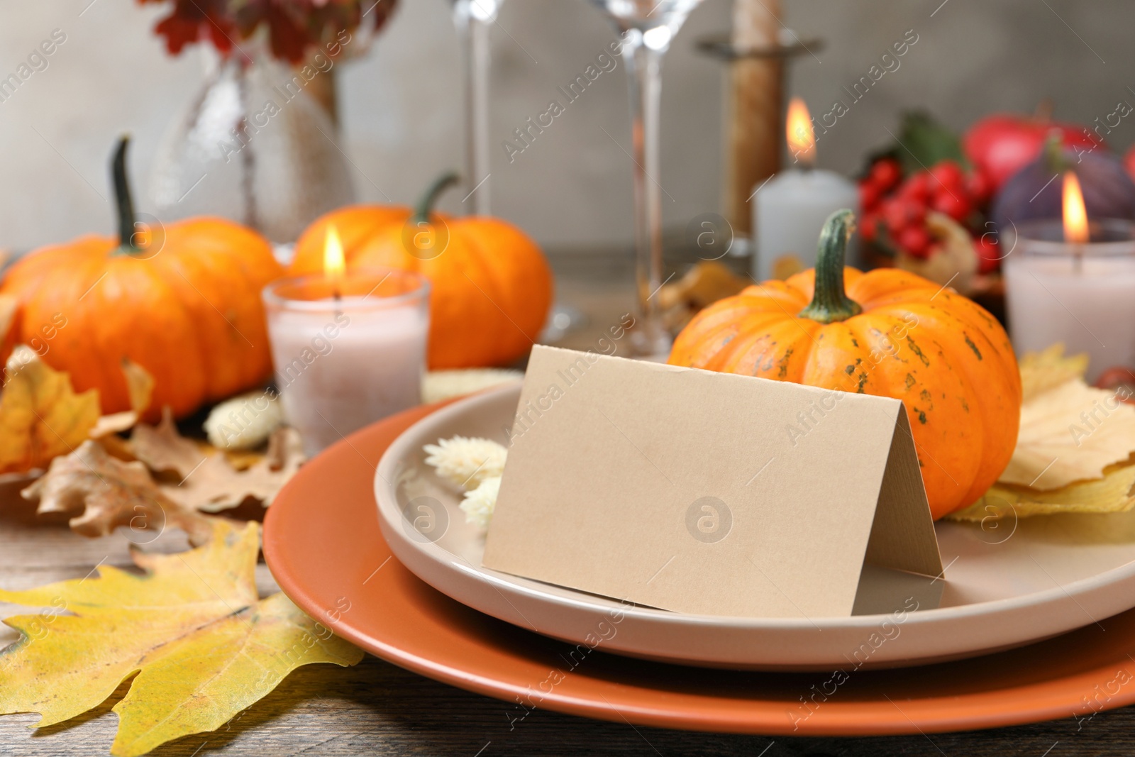 Photo of Beautiful autumn place setting with blank card and decor on wooden table