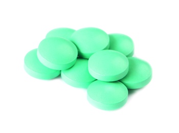 Photo of Pile of green pills on white background