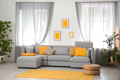 Living room with comfortable sofa and stylish decor. Idea for interior design