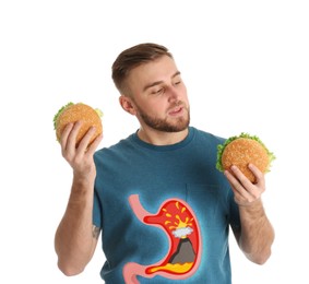 Image of Improper nutrition can lead to heartburn or other gastrointestinal problems. Man with burgers on white background. Illustration of stomach with erupting volcano as acid indigestion