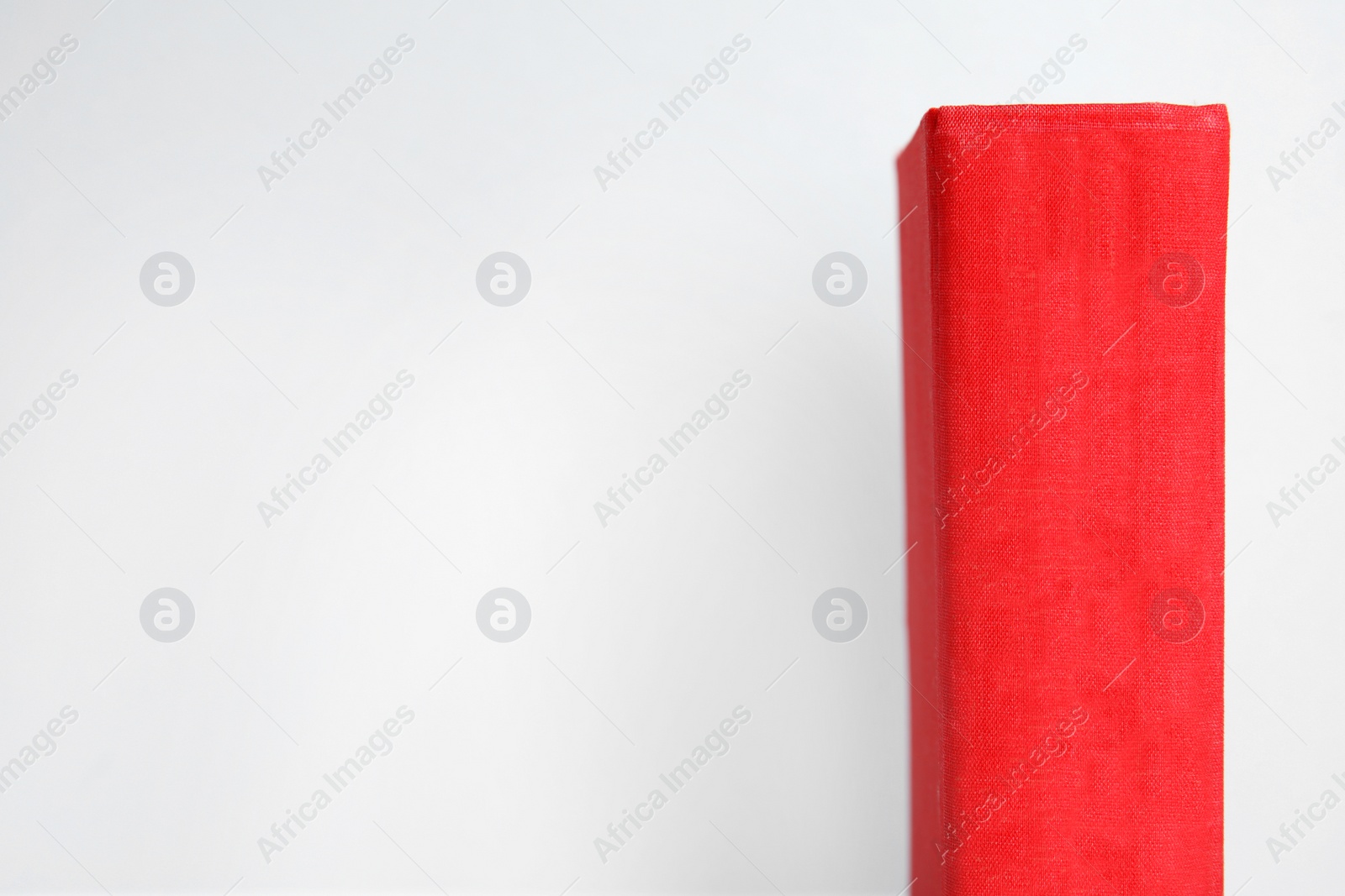 Photo of Old red book on light background, space for text