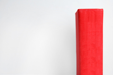 Photo of Old red book on light background, space for text