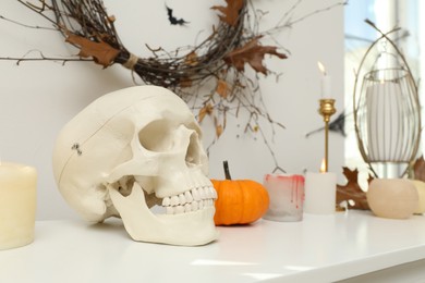 Photo of Different Halloween decor on table indoors. Festive interior
