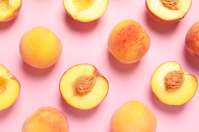 Flat lay composition with ripe peaches on color background