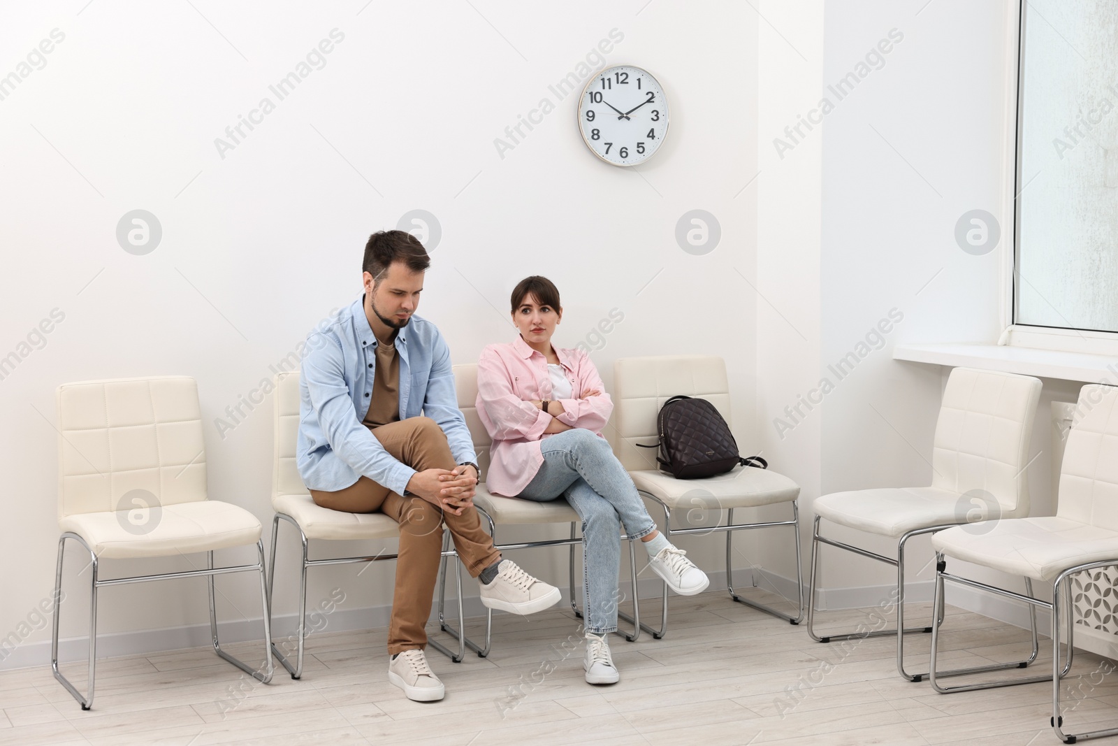 Photo of Man and woman waiting for appointment indoors