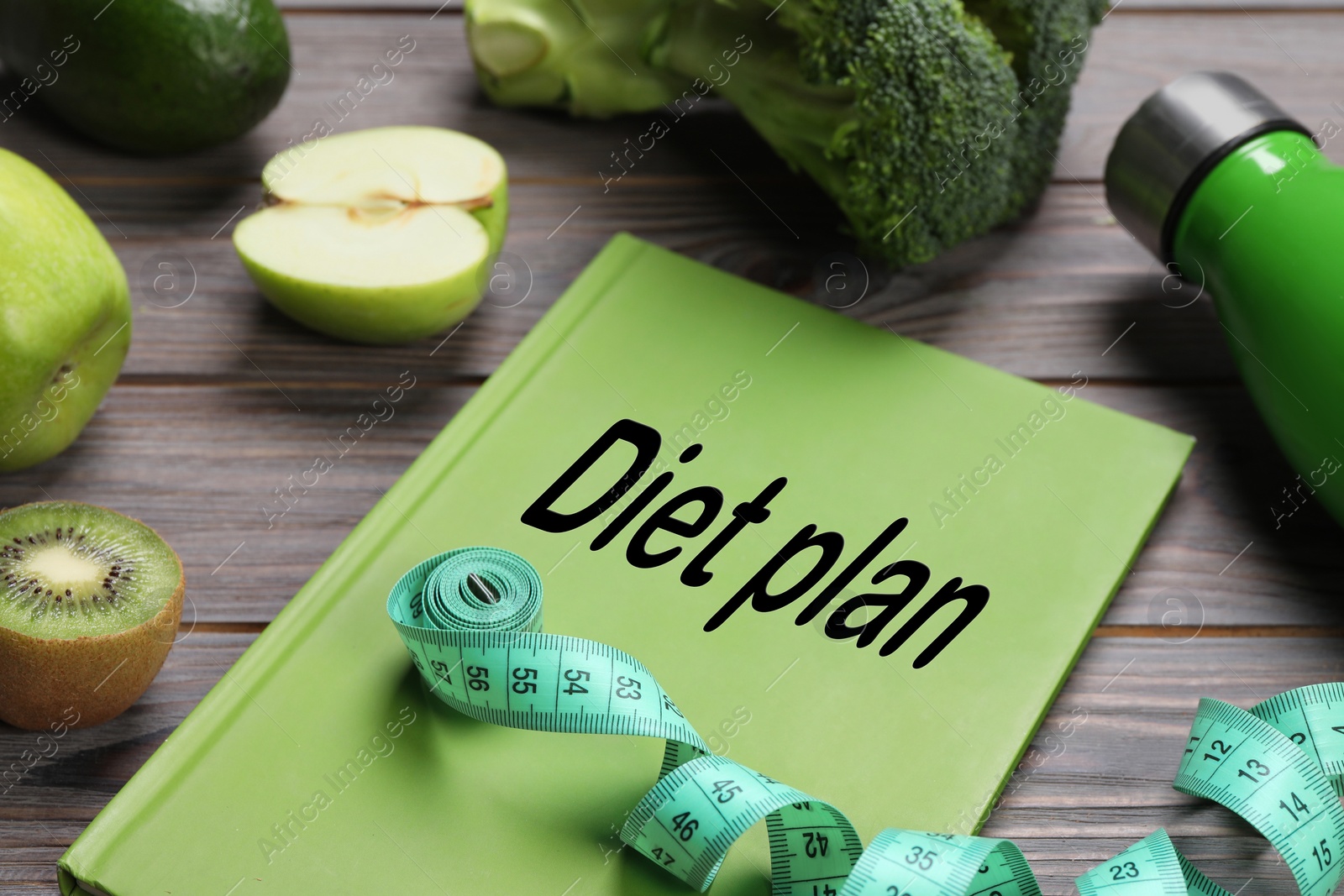 Photo of Weight loss concept. Composition with notebook, measuring tape and products on grey wooden table, closeup