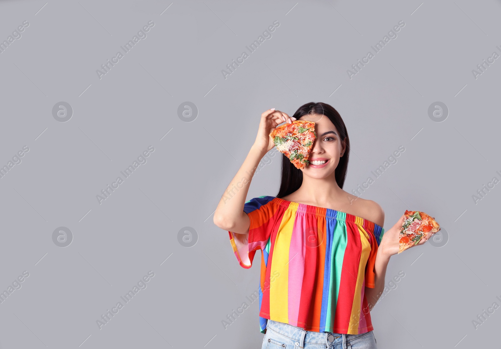 Photo of Beautiful woman with pizza on grey background. Space for text