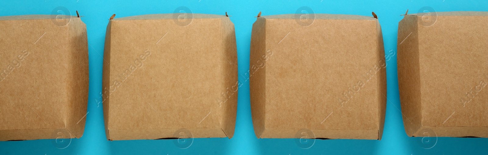 Image of Paper boxes on turquoise background, flat lay. Banner design