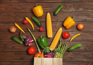 Flat lay composition with fresh vegetables on wooden background