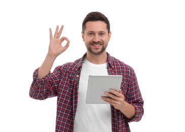 Photo of Happy man with tablet showing ok gesture on white background