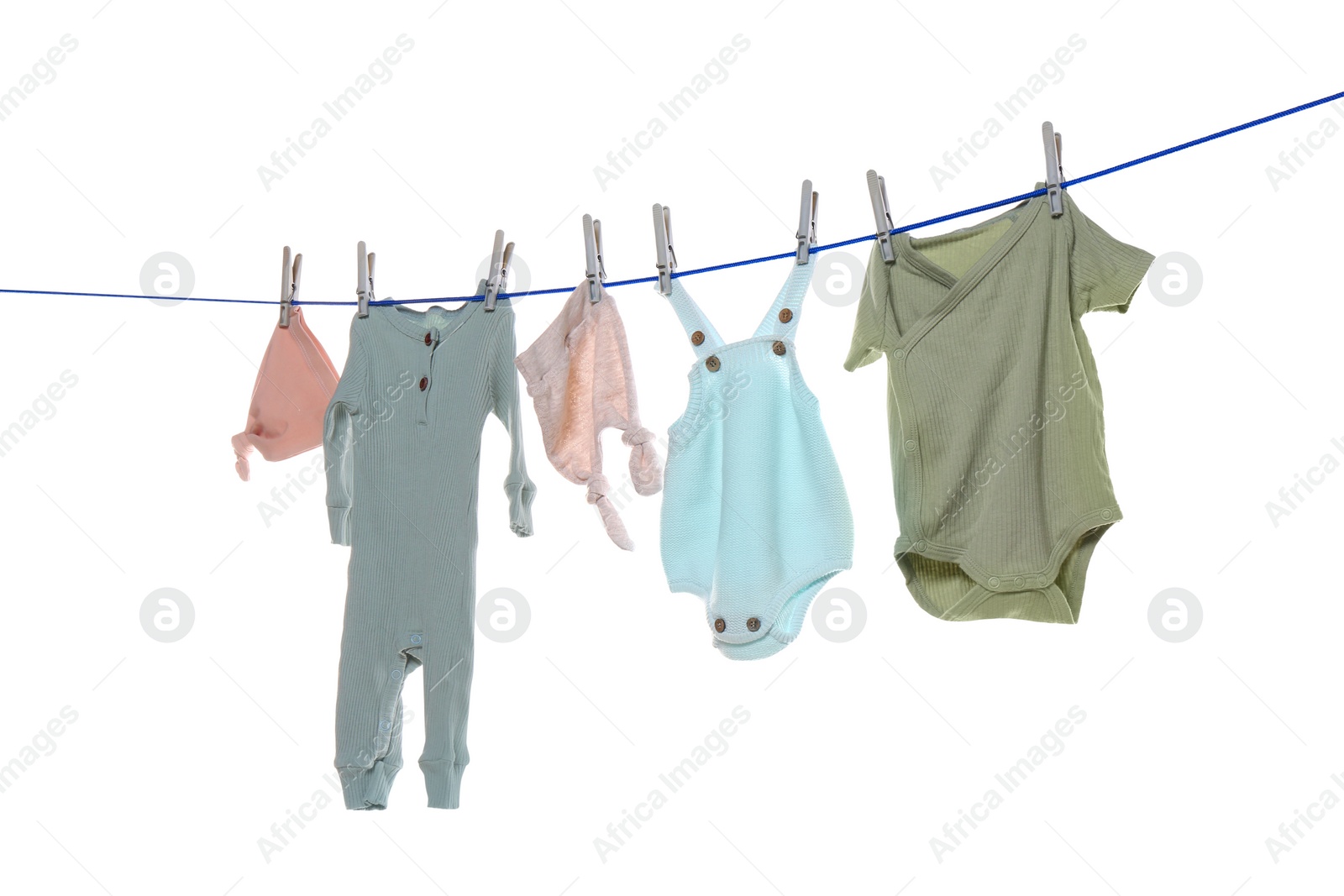 Photo of Colorful baby clothes drying on laundry line against white background