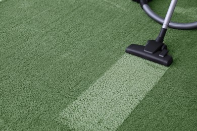 Image of Vacuuming carpet. Clean area after using device, closeup