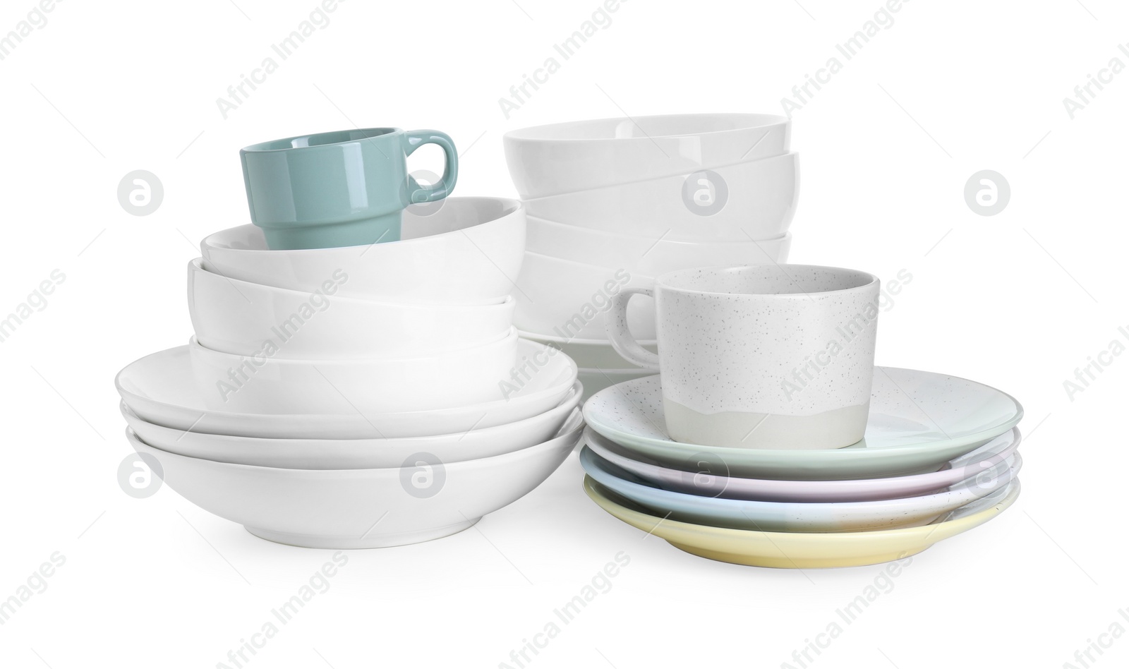 Photo of Beautiful ceramic plates, bowls and cups isolated on white