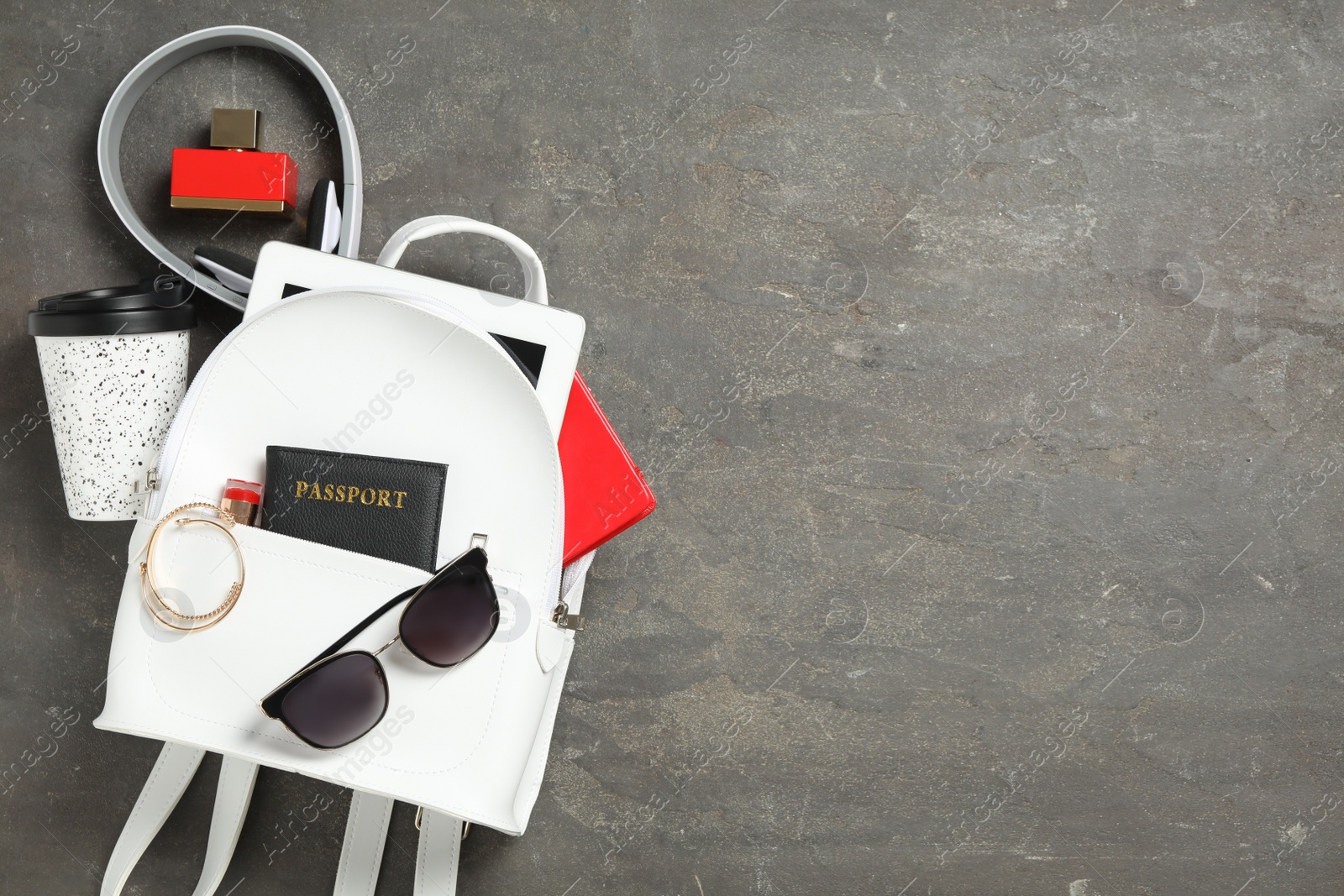 Photo of Stylish urban backpack and different items on black table, flat lay. Space for text