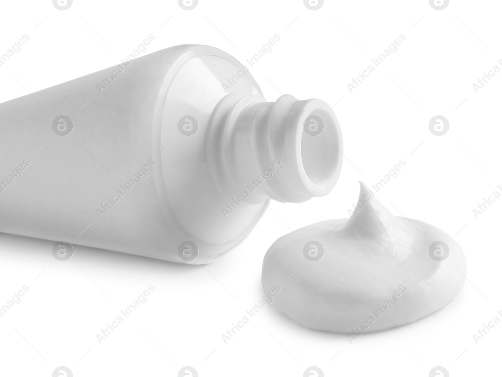 Photo of Blank tube and toothpaste on white background