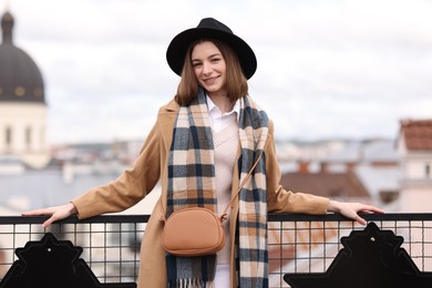 Beautiful woman in warm scarf and hat outdoors