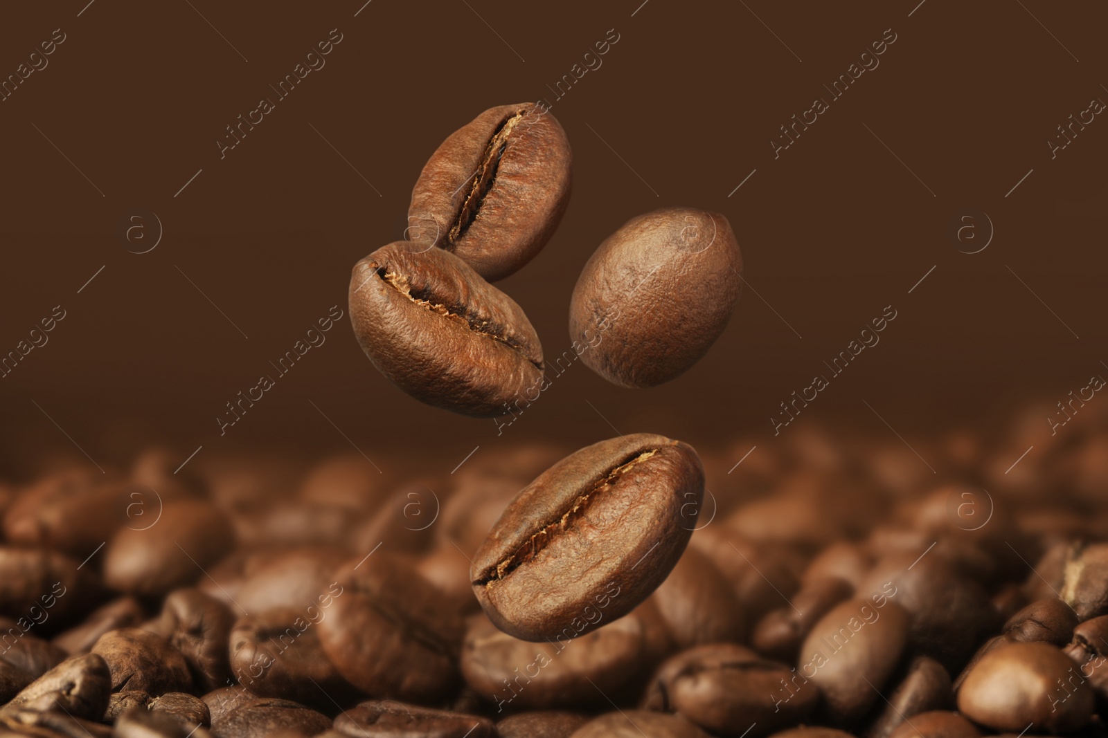 Image of Falling aromatic roasted coffee beans, closeup view