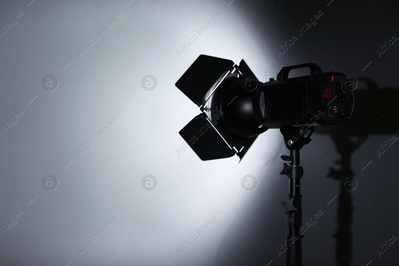 Photo of Professional photo studio lighting equipment on dark background. Space for text