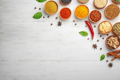 Photo of Flat lay composition with different aromatic spices on wooden background