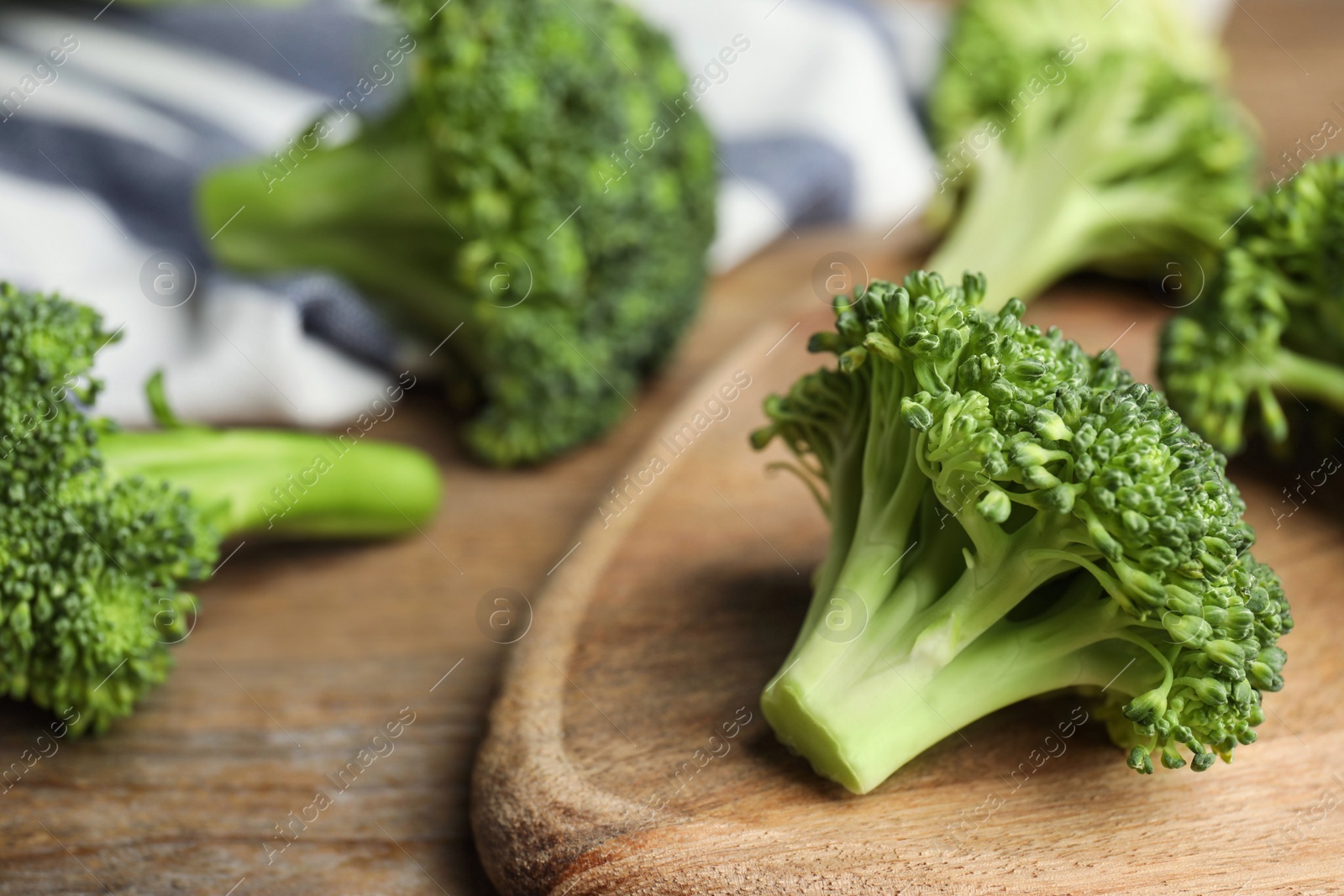 Photo of Fresh green broccoli on wooden table, closeup. Organic food