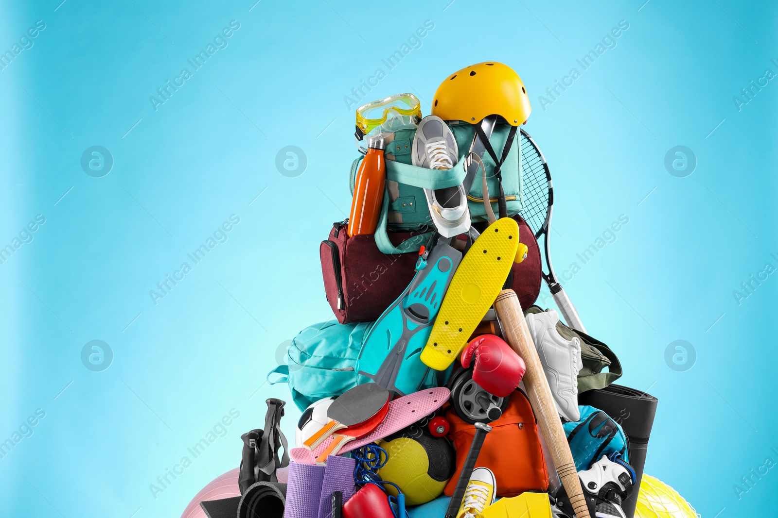 Photo of Many different sports equipment on light blue background