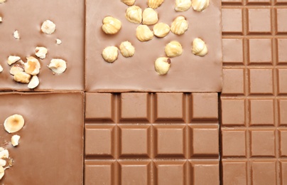 Photo of Different delicious milk chocolate bars as background