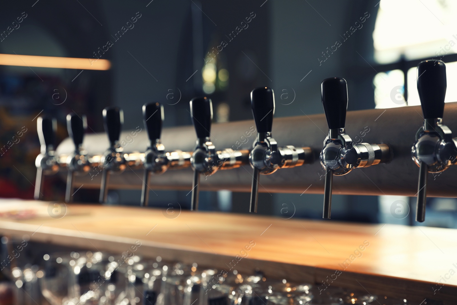 Photo of Row of shiny beer taps in pub