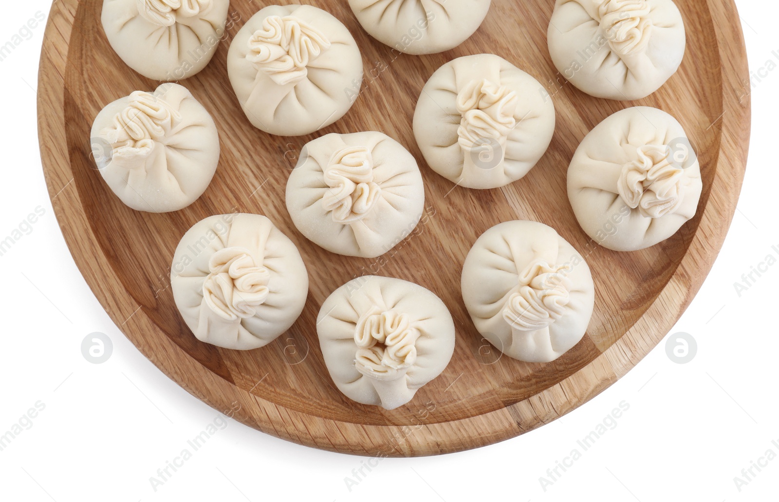 Photo of Board with uncooked khinkali (dumplings) isolated on white, top view. Georgian cuisine