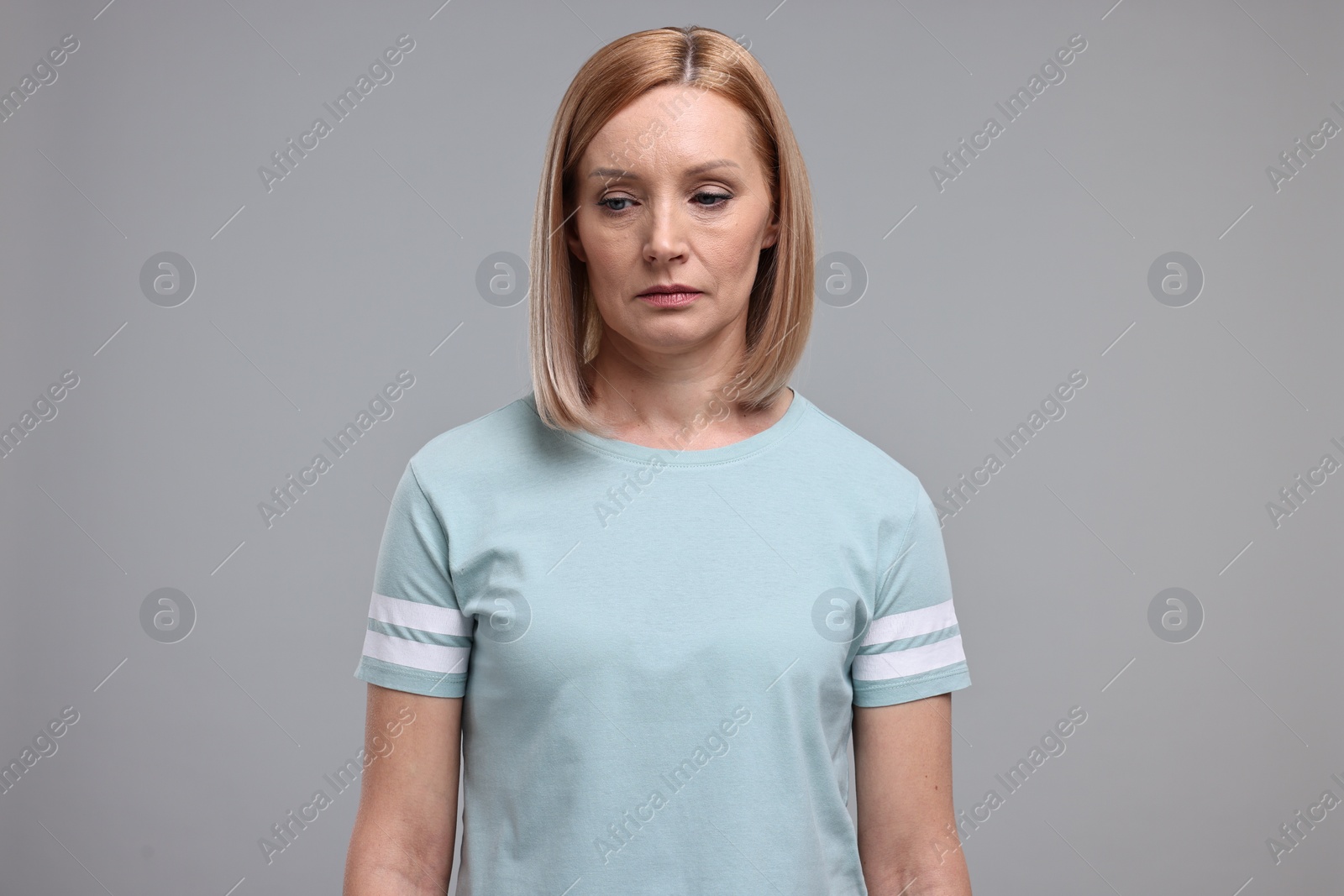 Photo of Portrait of sad woman on grey background