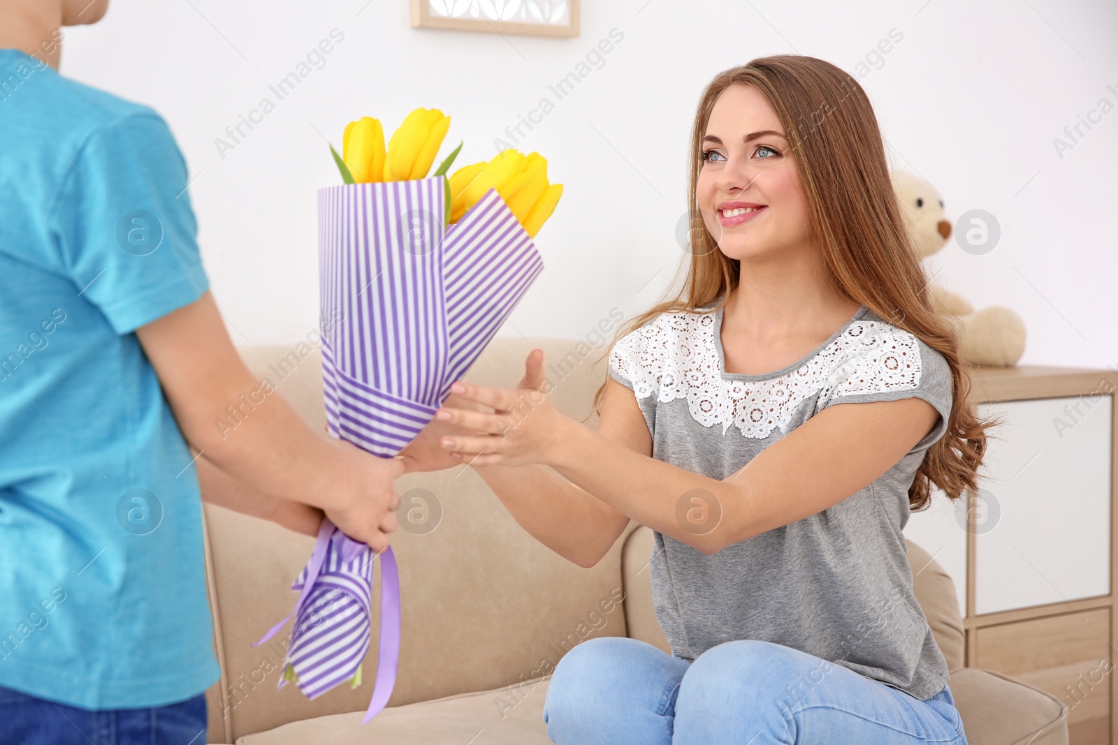 Photo of Little boy congratulating mother at home