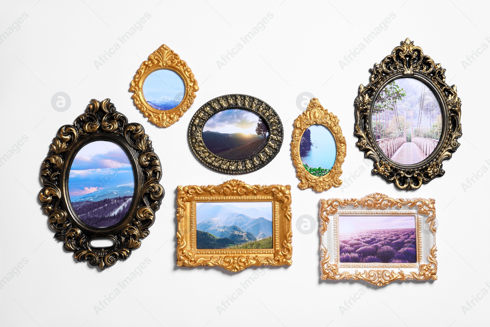 Photo of Vintage frames with photos of beautiful landscapes hanging on white wall