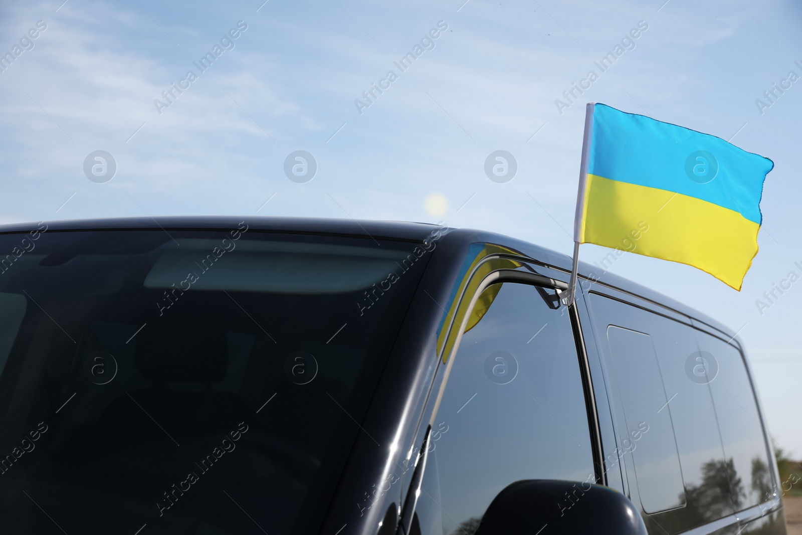 Photo of National flag of Ukraine on car window outdoors