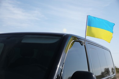 Photo of National flag of Ukraine on car window outdoors