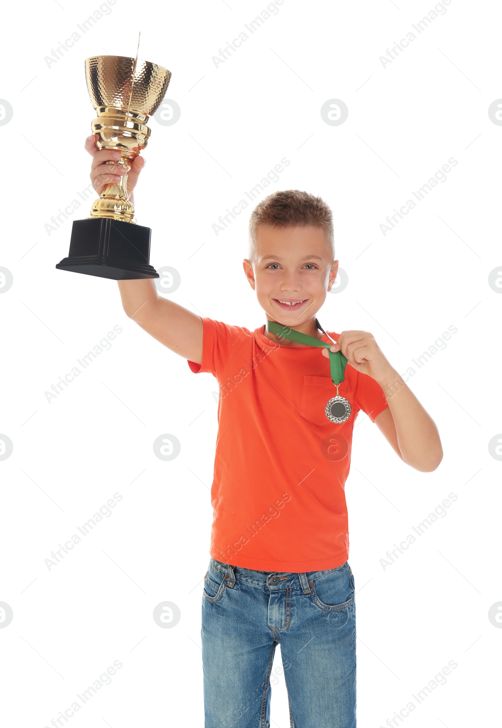 Photo of Happy boy with golden winning cup and medal isolated on white