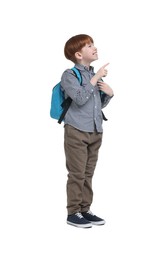 Photo of Little boy with backpack pointing at something on white background