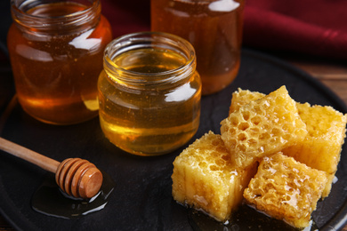 Photo of Composition with fresh honey on slate board