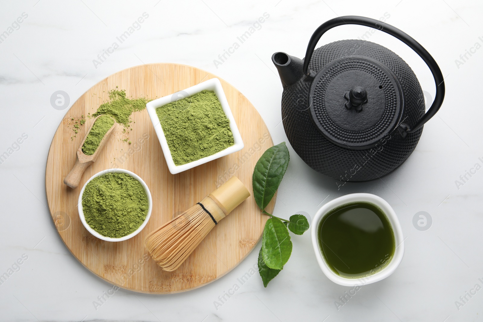 Photo of Flat lay composition with green matcha powder on white marble table