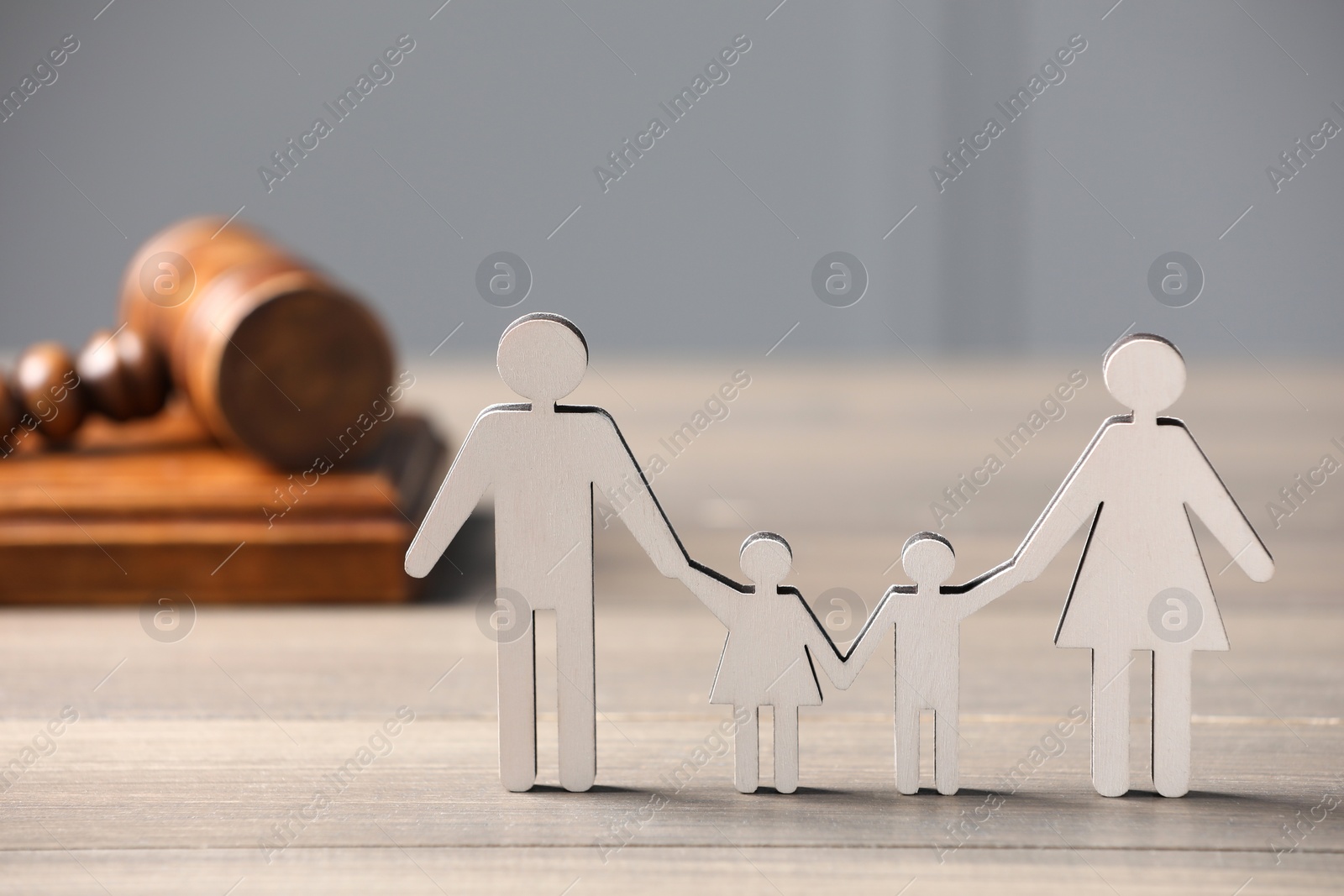 Photo of Family law. Figure of parents with children and gavel on wooden table, space for text