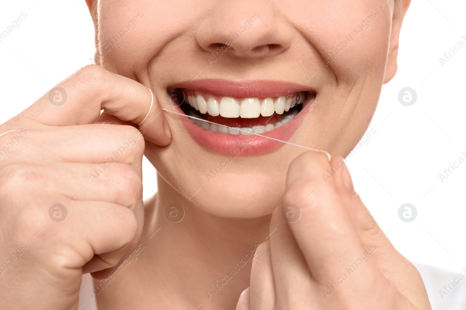 Photo of Young woman flossing her teeth on white background, closeup