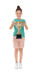 Happy girl with golden winning cup isolated on white