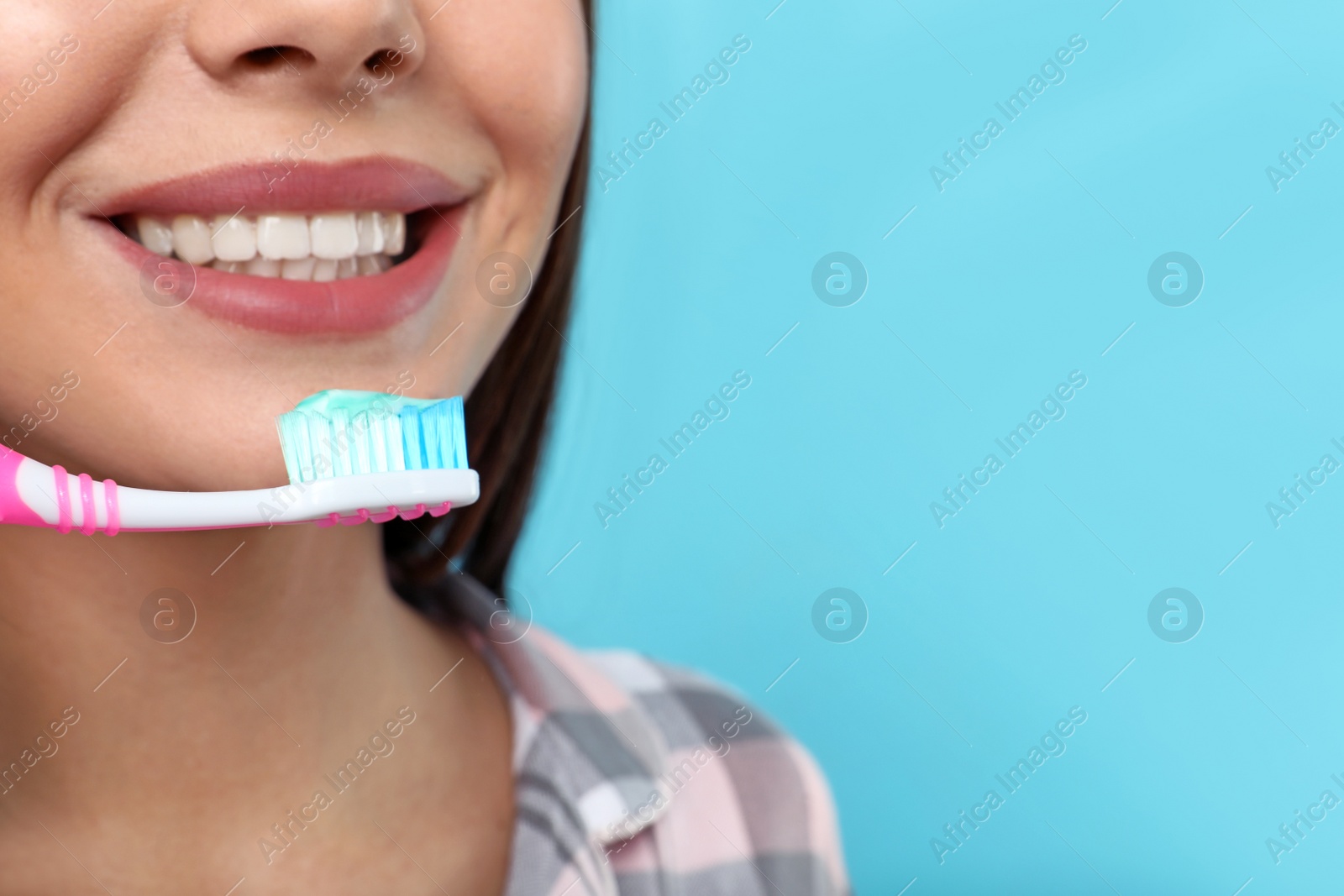 Photo of Beautiful woman brushing teeth on color background, closeup. Space for text