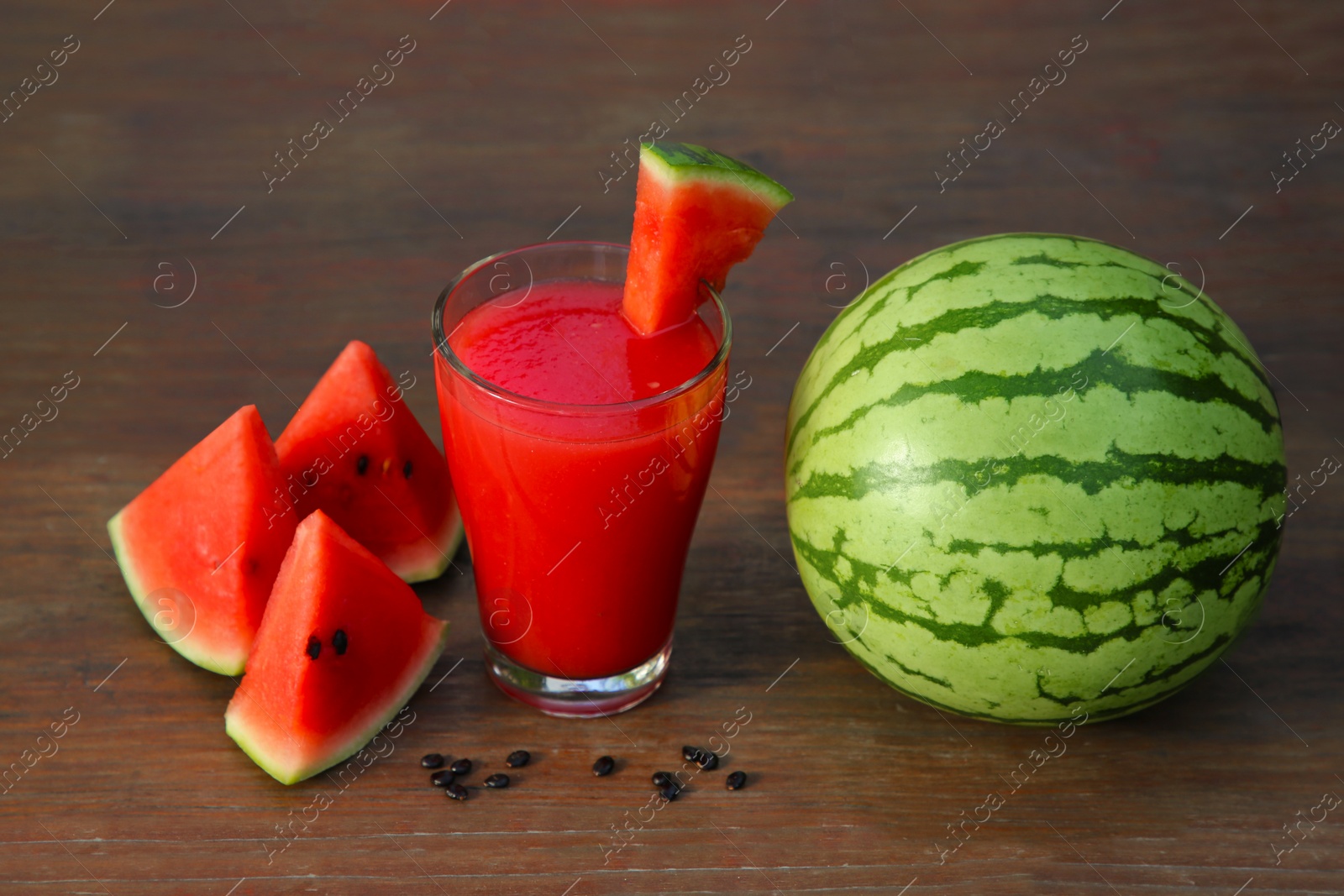 Photo of Delicious watermelon drink and fresh fruit on wooden table