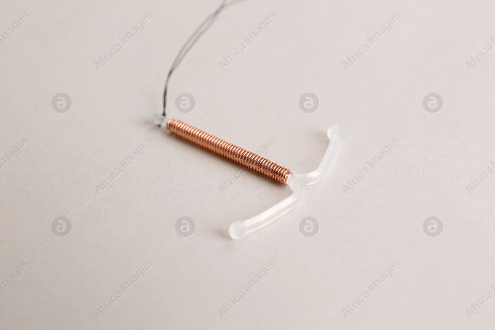 Photo of Copper intrauterine contraceptive device on light background