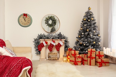 Stylish Christmas interior with decorated fir tree and fireplace